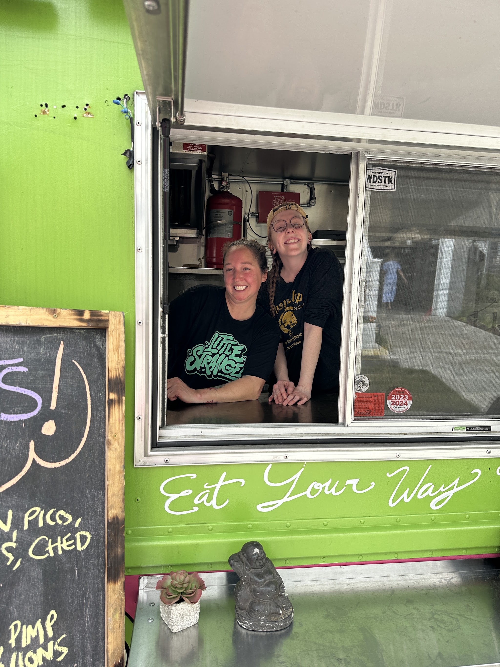 Two of us smiling from the truck window under the words Eat Your Way